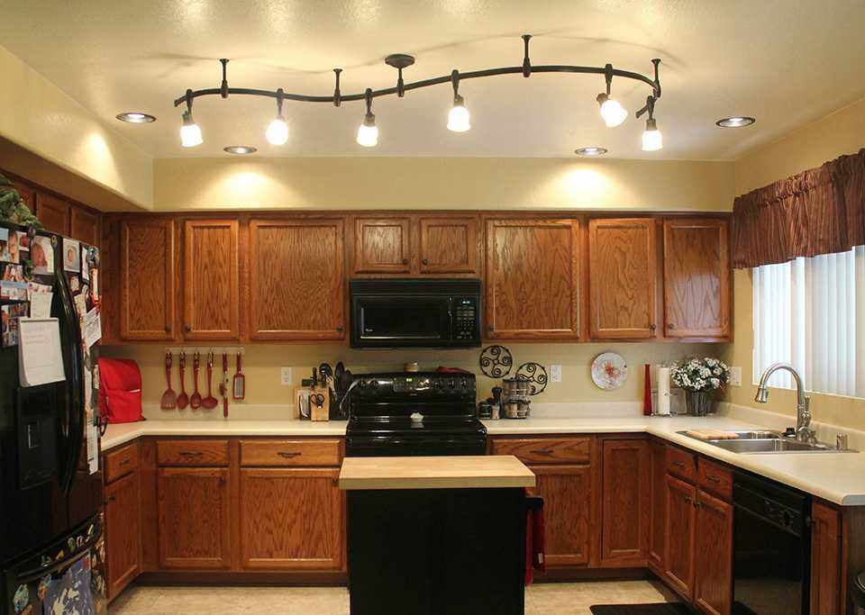 Освещение из люстры и светильников в интерьере кухни